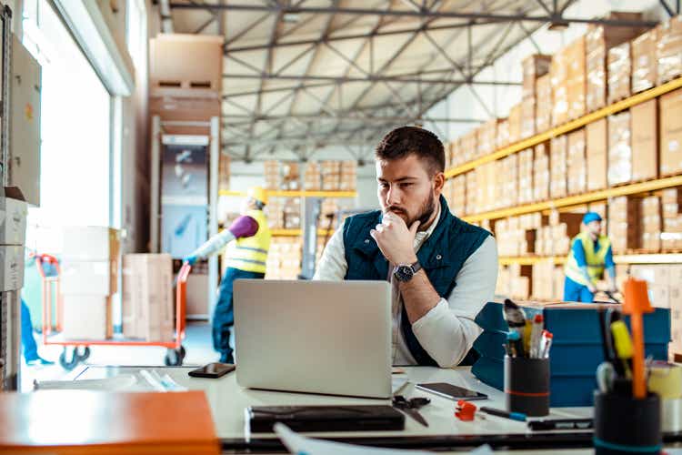 Warehouse Manager using a laptop