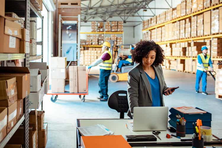 Warehouse Manager using a laptop