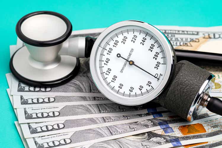 Stethoscope, sphygmomanometer and cash.  Healthcare, health insurance and medical bills concept.