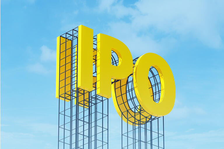 Large yellow signboard on metal frame with the word IPO