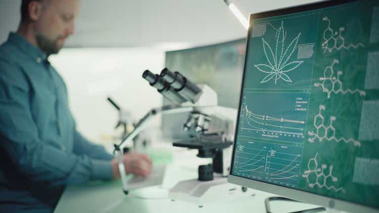 Scientist testing medical marijuana. Charts and models on computer screens. Modern laboratory interior