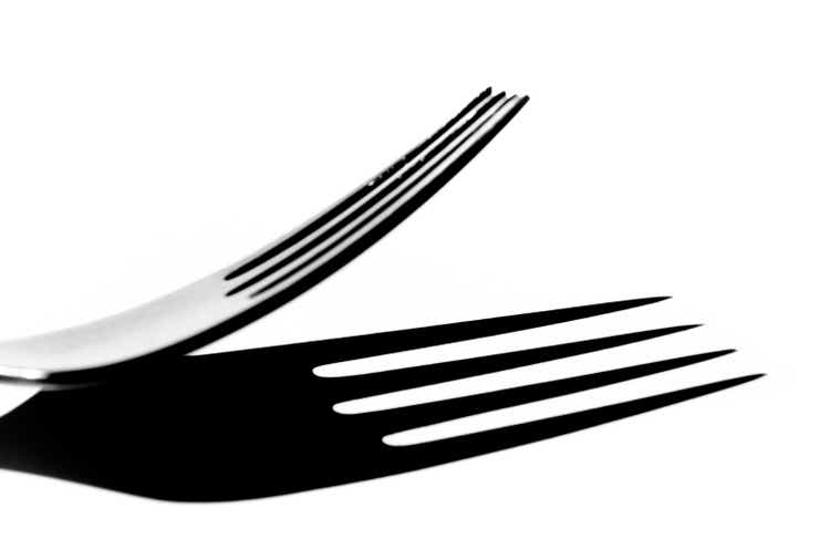 Close-up of a fork with hard shadow