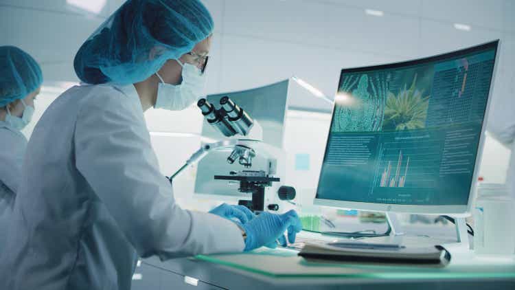 Female scientist testing medical marijuana. Charts and models on computer screens. Modern laboratory interior