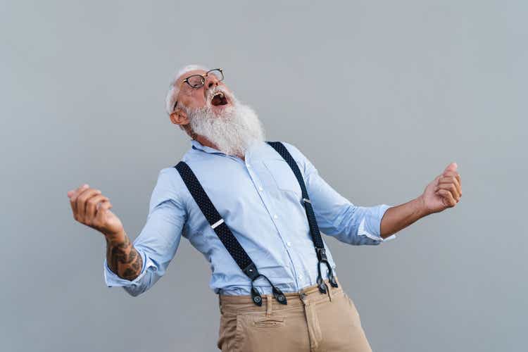 Happy trendy senior man having fun dancing in front camera - Fashion elderly male lifestyle concept