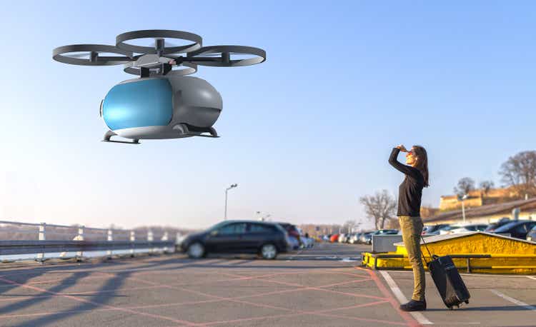 flying transportation drone picking up a passenger