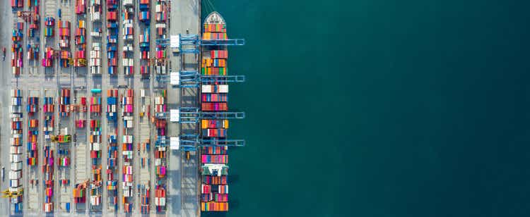 Aerial view container ship in port at container terminal port, Ship of container ship stand in terminal port on loading, unloading container, Commercial cargo ship in sea port.