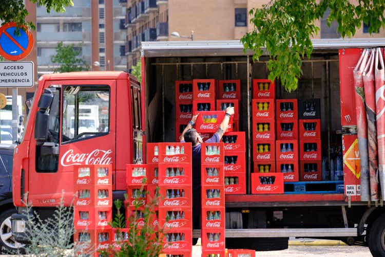 A delivery man unloads boxes of Coca-Cola in the city of Valencia.