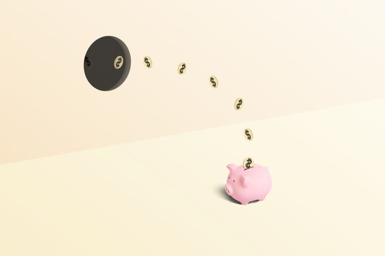 Piggy bank being stuffed with money