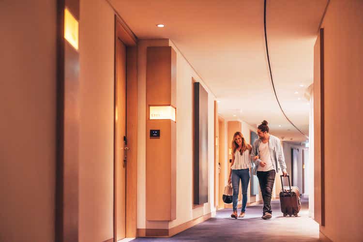 Couple walking through a luxury hotel corridor