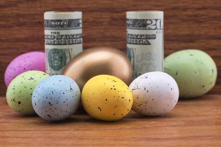 Diversified American investment symbolized with gold egg and colorful eggs