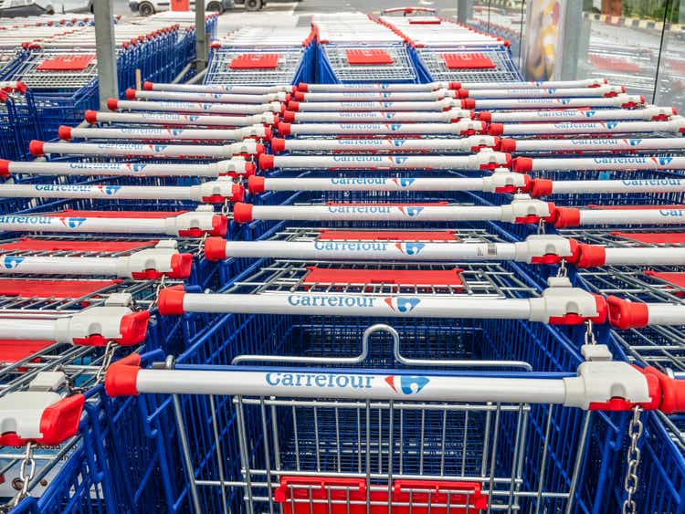 Shopping carts belonging to Carrefour Hypermarket. Logo of the French retailer Carrefour