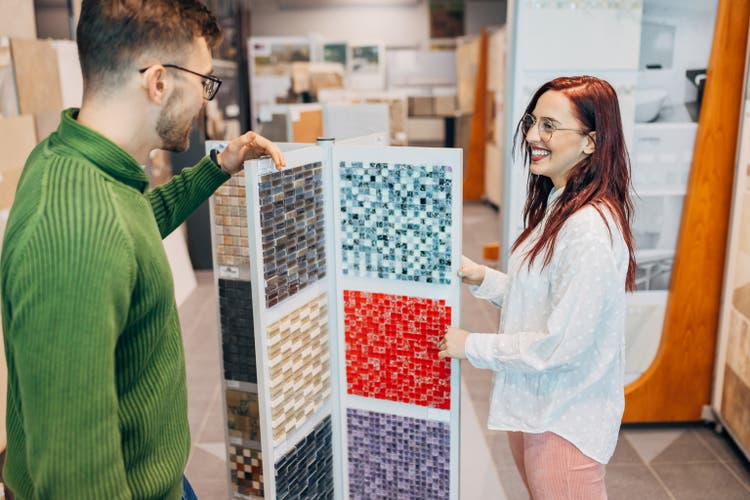 Cheerful young couple having so much fun while shopping at the home goods store