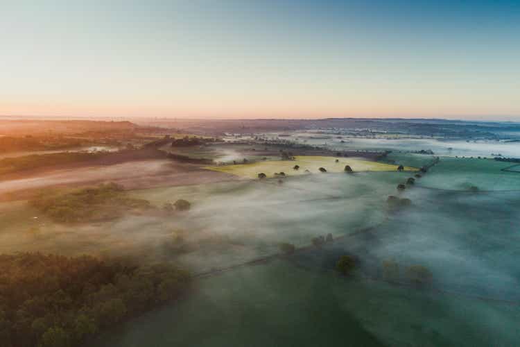 Aerial shot showing a low level mist at sunrise over the English countryside, England, United Kingdom