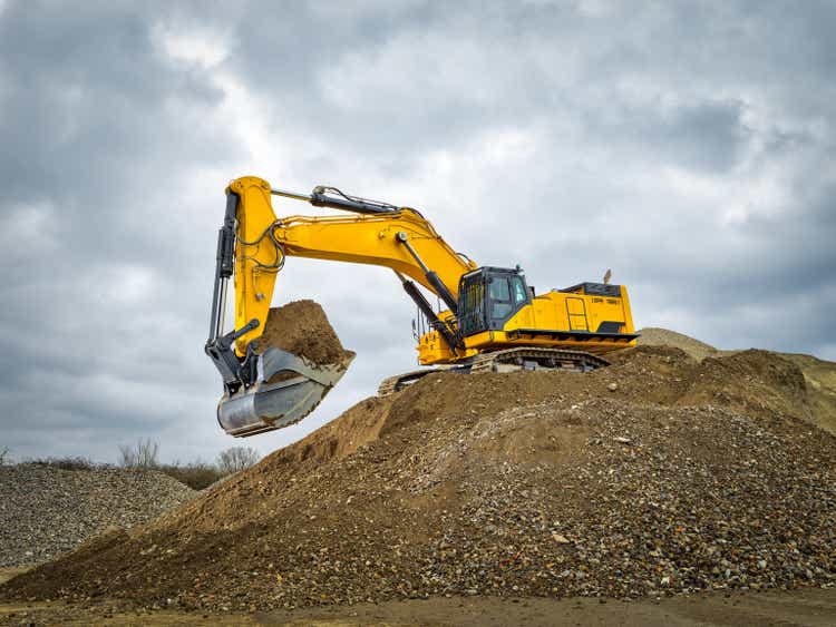 Excavator blue sky heavy machine construction site