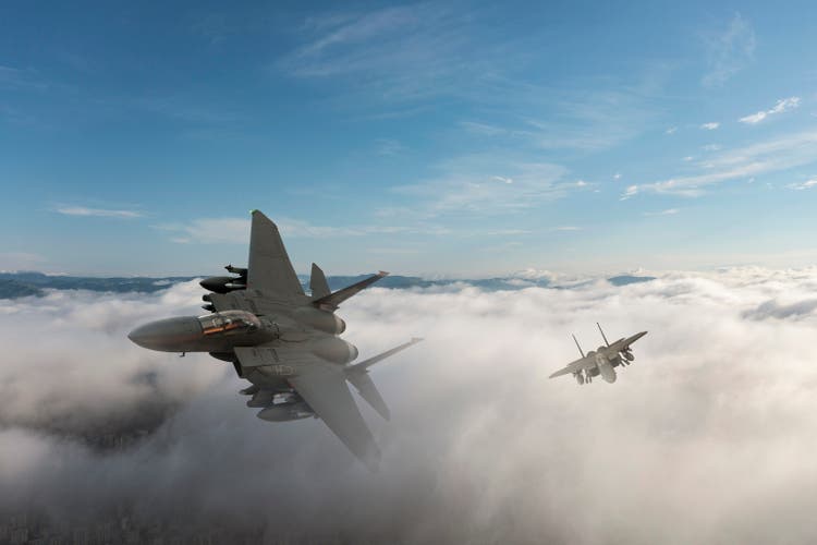 Jet fighters flying over the clouds.