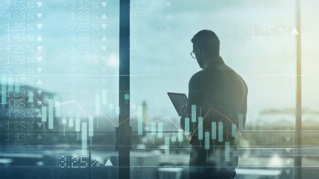 Digitally enhanced shot of an unrecognizable businessman using a tablet superimposed over a graph showing the ups and downs of the stock market