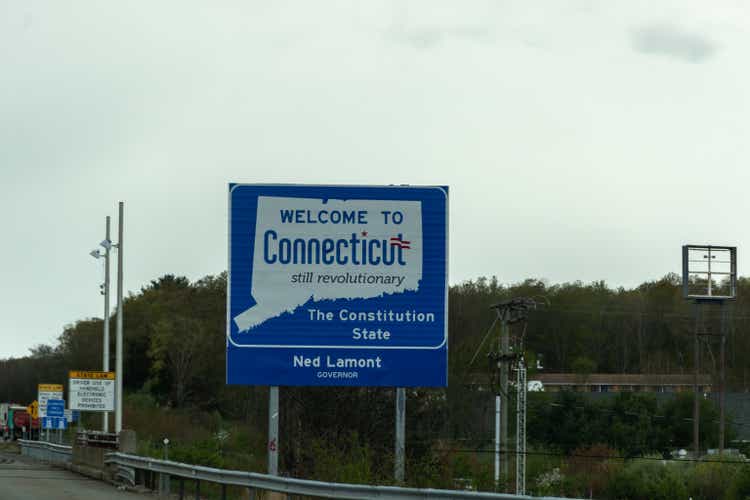 Welcome to Connecticut sign on a gray cloudy day with road construction signs