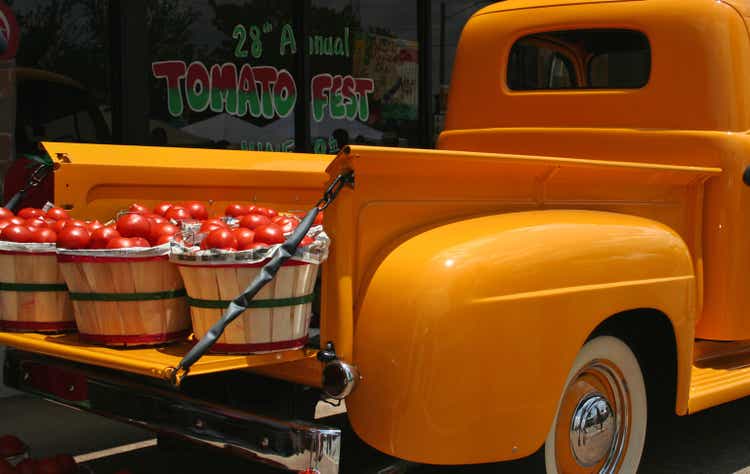 Vintage Yellow Truck with baskets of Red Tomatoes