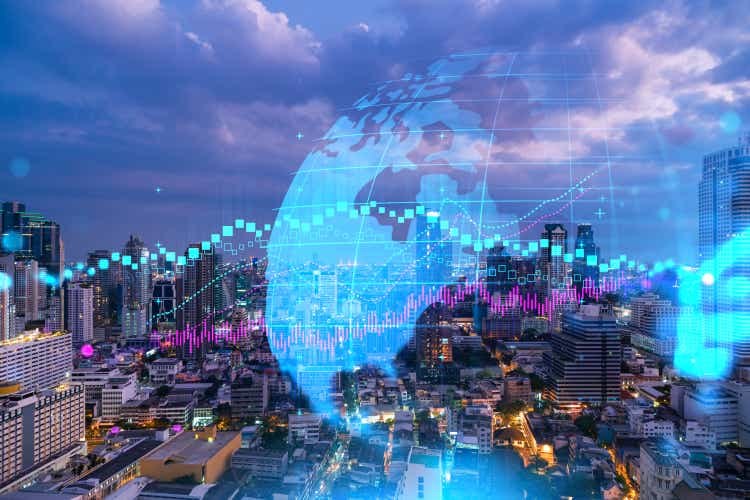 FOREX graph hologram, aerial night panoramic cityscape of Bangkok, the developed location for stock market researchers in Asia. The concept of fundamental analysis. Double exposure.