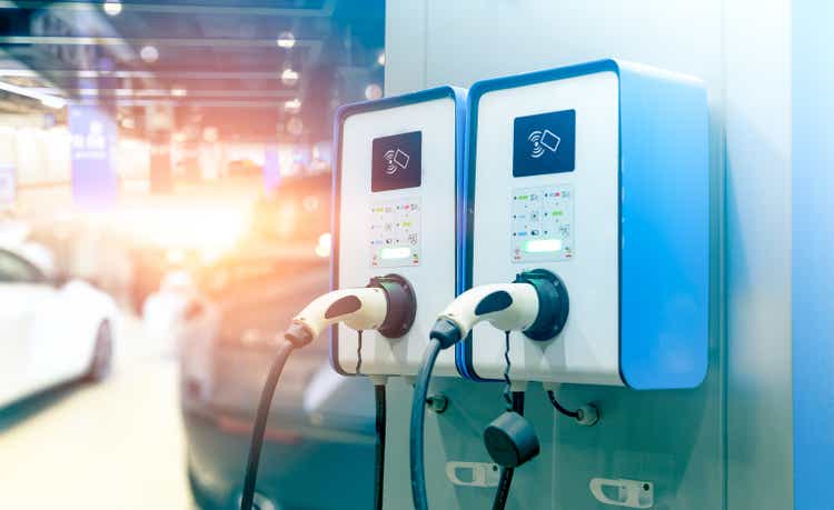 Electric car charging station for charging EV battery.  Plug for vehicle with electric engine.  EV charger station.  Clean energy.  Charging point for EV car.  Green power.  Future transport technology.