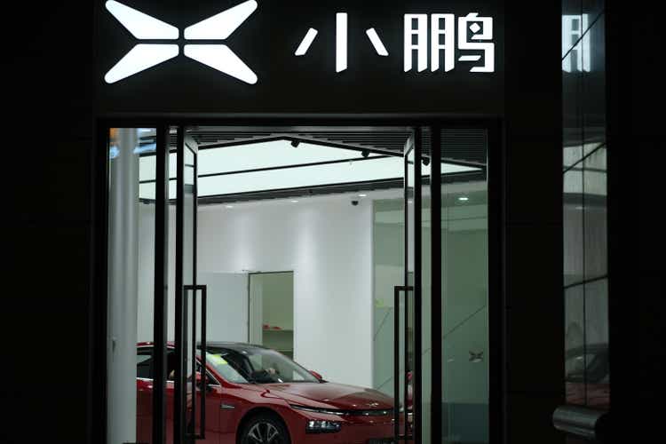 Xpeng Motors"s store sign at night. Electric car in store