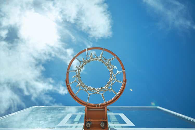 Cropped shot of a basketball net on a sunny day outside