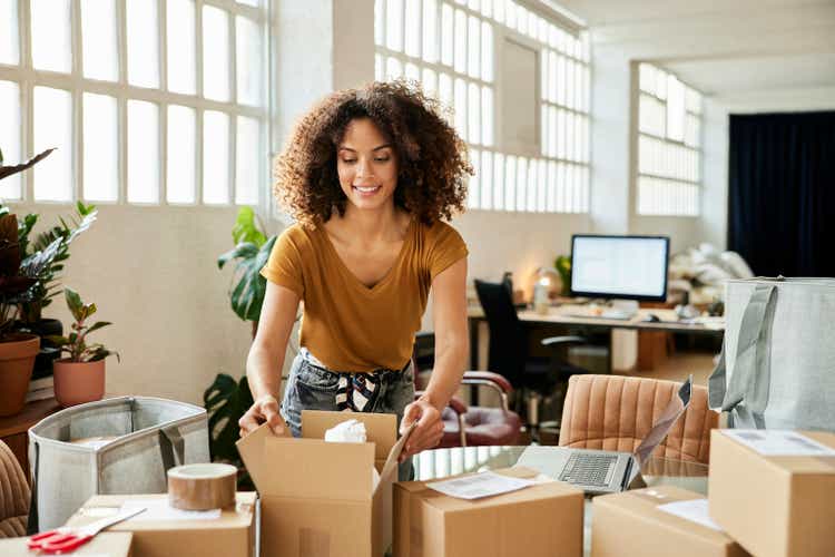 Female Entrepreneur Packing Boxes At Home