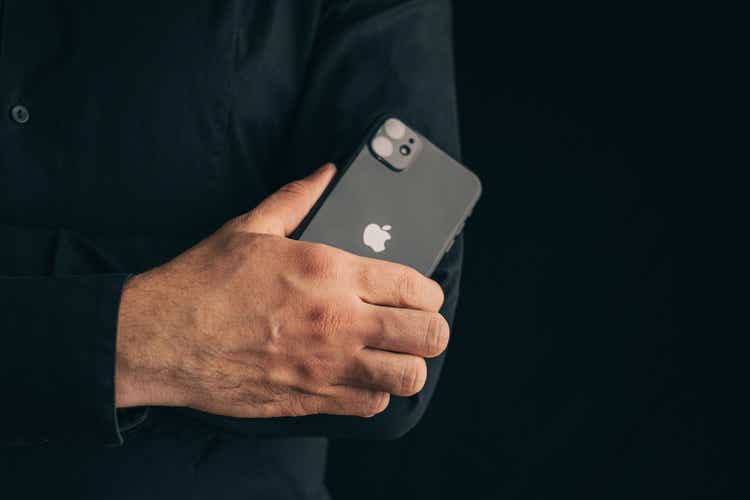 Man folding his arms cross to cross on his chest with iphone 11.