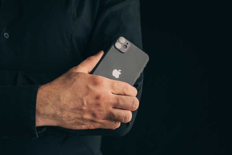 Man folding his arms transverse  to transverse  connected  his thorax  with iphone 11.