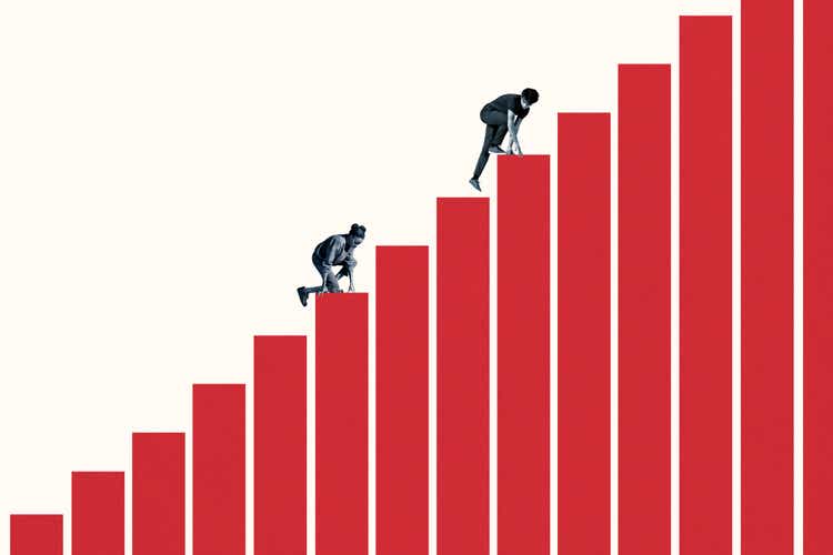 Young woman and man climbing red bar graph