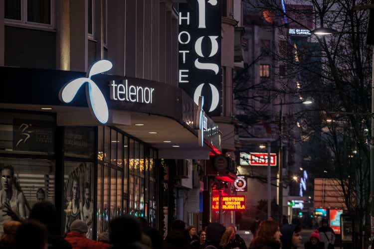 Selective blur on a Telenor logo in front of their main shop in Belgrade at night. Telenor ASA is a Norwegian internet service provider and phone carrier.