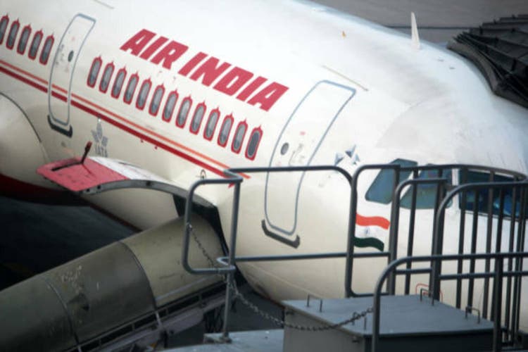 Loading luggage in airplane.