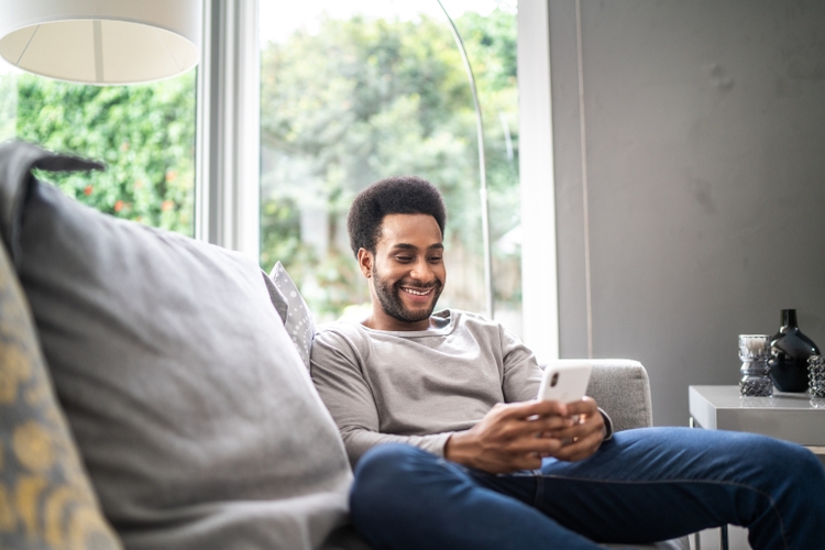 Man using smartphone at home