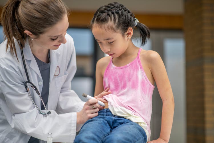 Girl with diabetes at a doctor"s appointment