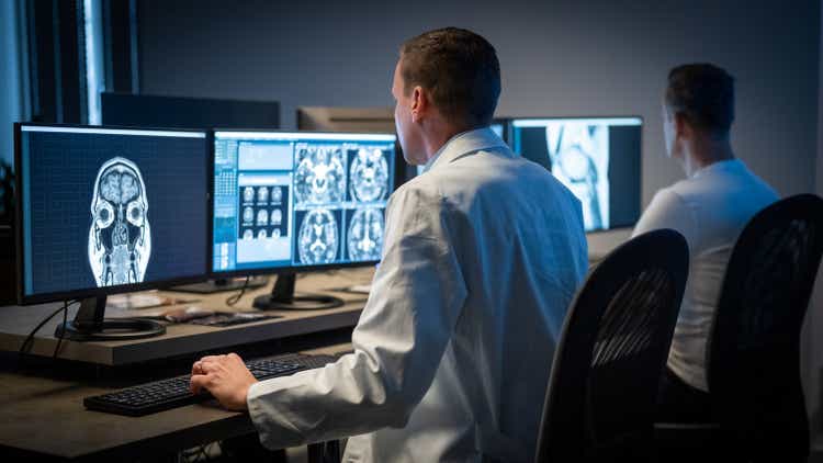 Male radiologist analysing the MRI image of the head