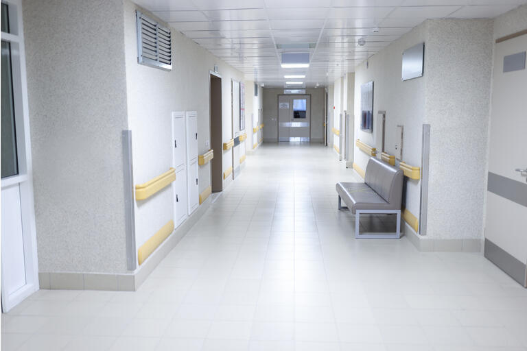 Empty modern hospital corridor with sitting couch