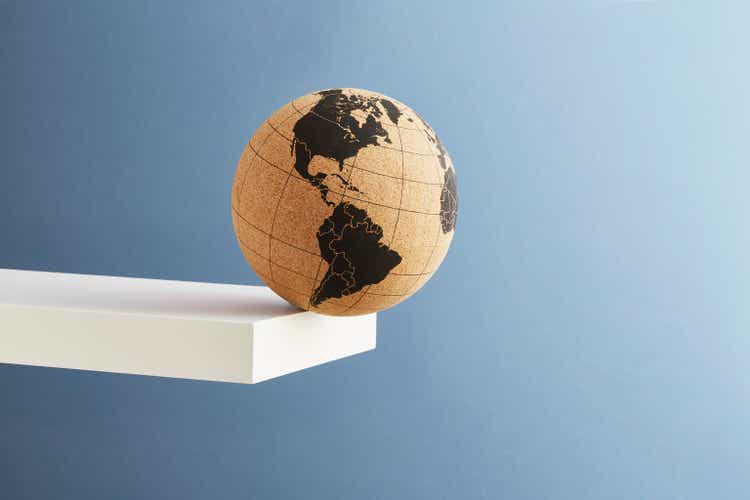 A world globe balanced on the edge of a shelf