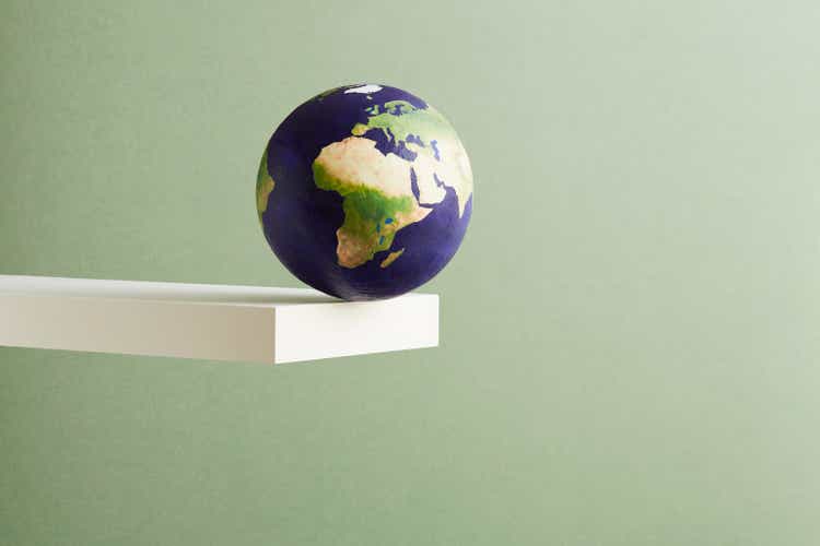 A world globe balanced on the edge of a shelf