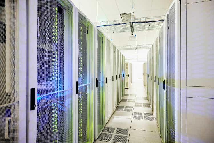 Wide shot down rows of server racks in data center