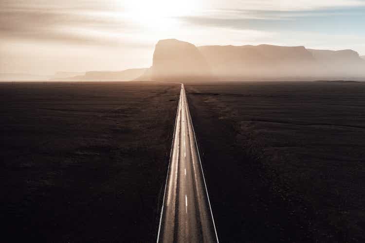 Endless straight road into the sun on Iceland