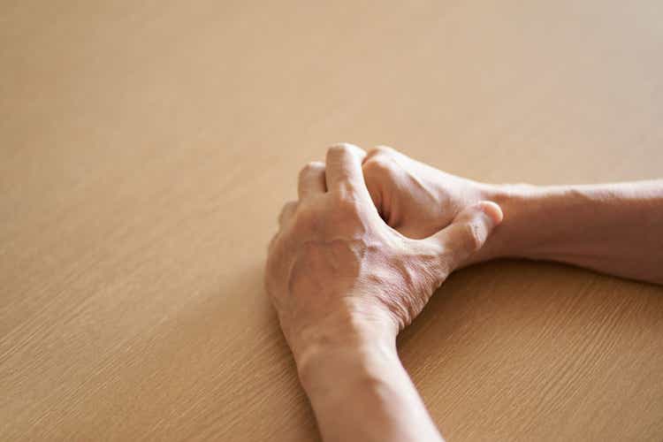 Hands of anxious elderly people