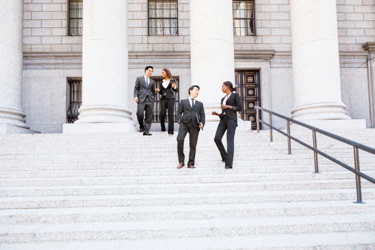Four People Walk Down Courthouse Steps
