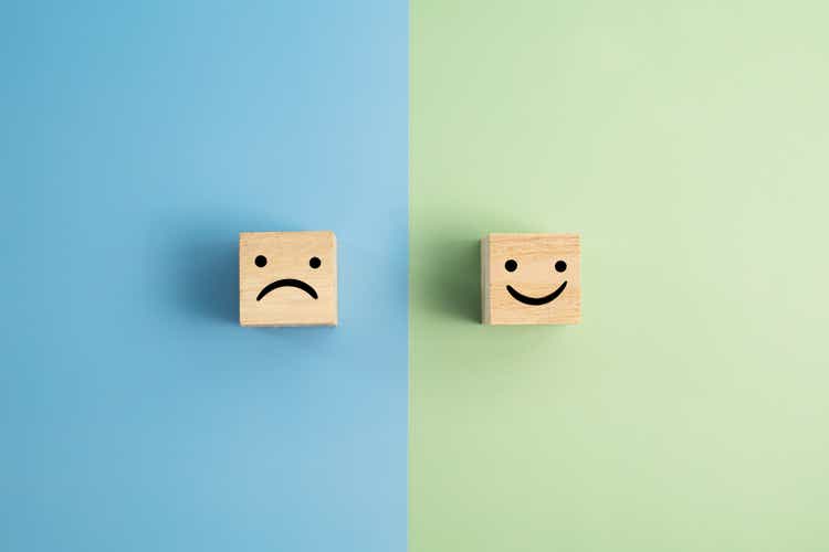 Angry And Smiley Face Wooden Blocks On Colored Background