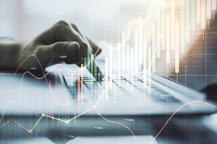 Multi exposure of abstract financial graph with hand typing on laptop on background, financial and trading concept