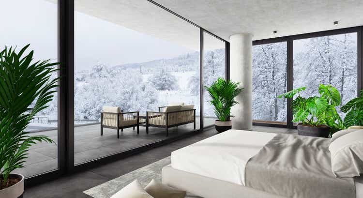 Luxury Hotel Modern interior bedroom with large windows. Winter scene mountain forest..