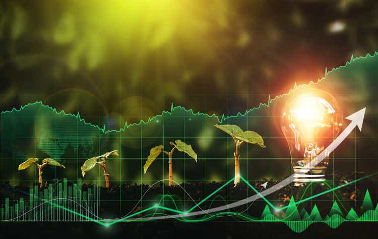 Lightbulb is located on the soil, and plant are growing with digital growth graph. Alternative sources of energy. Green energy, eco energy concept.Renewable energy generation is essential.