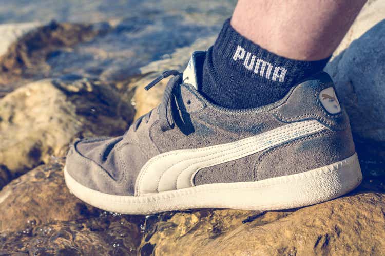 Puma shoe and sock on the riverbank