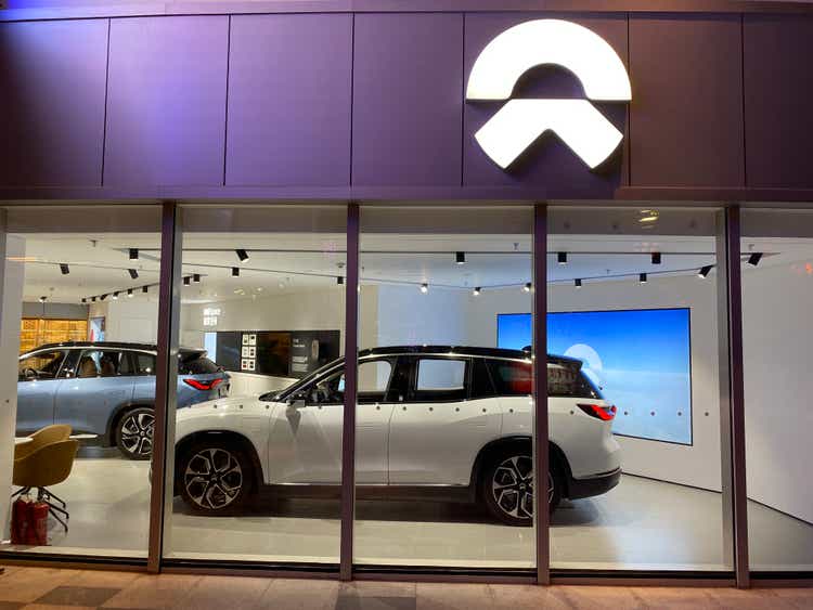 Nio brand logo and electric car in store