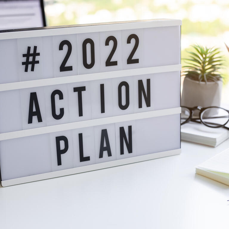 2022 action plan text on light box on desk table in office