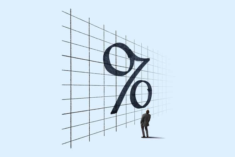 Man Looking Up At Percent Sign On A Chart
